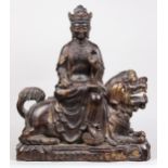 Chinese gilt alloy sculpture of Manjusri, seated in laliasana on a lion and holding a scroll, 21"h