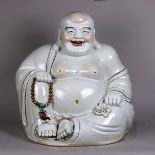 Chinese gilt porcelain Budai, seated in royal ease, holding a strand of prayer beads, and a large