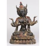 Chinese gilt lacquered copper alloy bodhisattva, with three heads and six arms, seated on a double