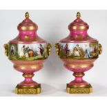 Pair of large French porcelain urns, circa 1900, each having a lid with gilt finial, above the