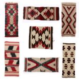 (lot of 7) Navajo gallup throws, circa 1930, largest: 1'3" x 3' Provenance: Family descent,