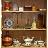 Three shelves of decorative art, including a partial porcelain tea service, a cruet set, an envelope