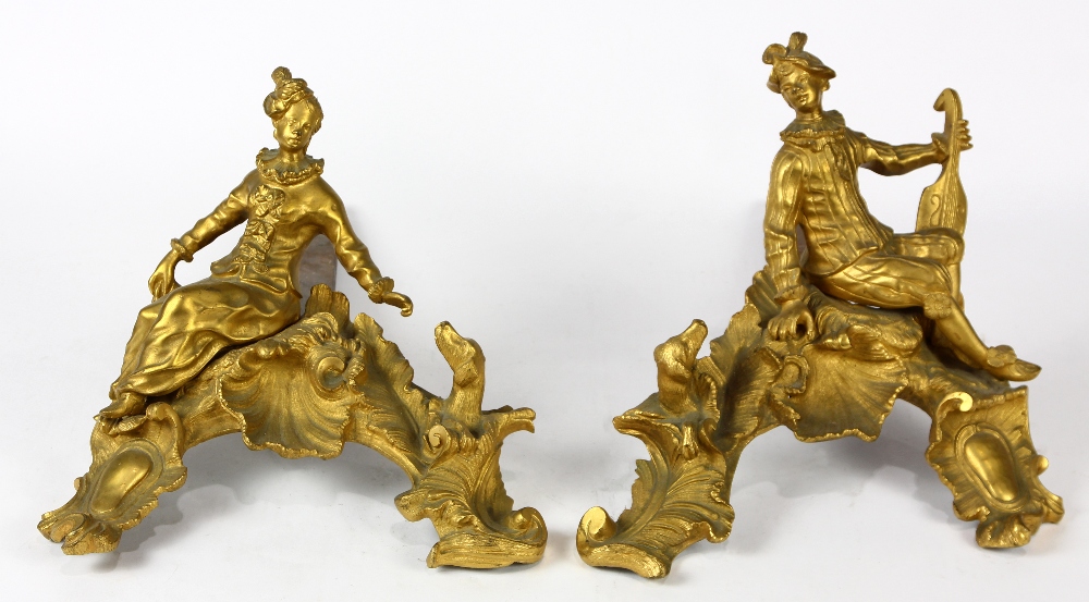 Pair of Louis XV style gilt bronze andirons, each decorated with a figure of a youth dressed in