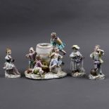 (lot of 4) Continental porcelain figural groups, consisting of a Meissen example depicting putti