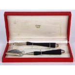 (lot of 2) Cartier silver utensil group, consisting of a sterling and wood handle pusher, 7"l;