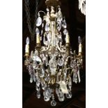 Continental crystal chandelier, having a gilt support suspending the six lights with lavender and