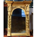 Renaissance style gilt looking glass, having an architectural crest surmounting the shaped looking