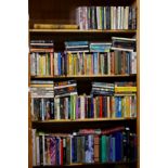 Four shelves of books, relating to yoga, religion and psychology, consisting of hard bound and