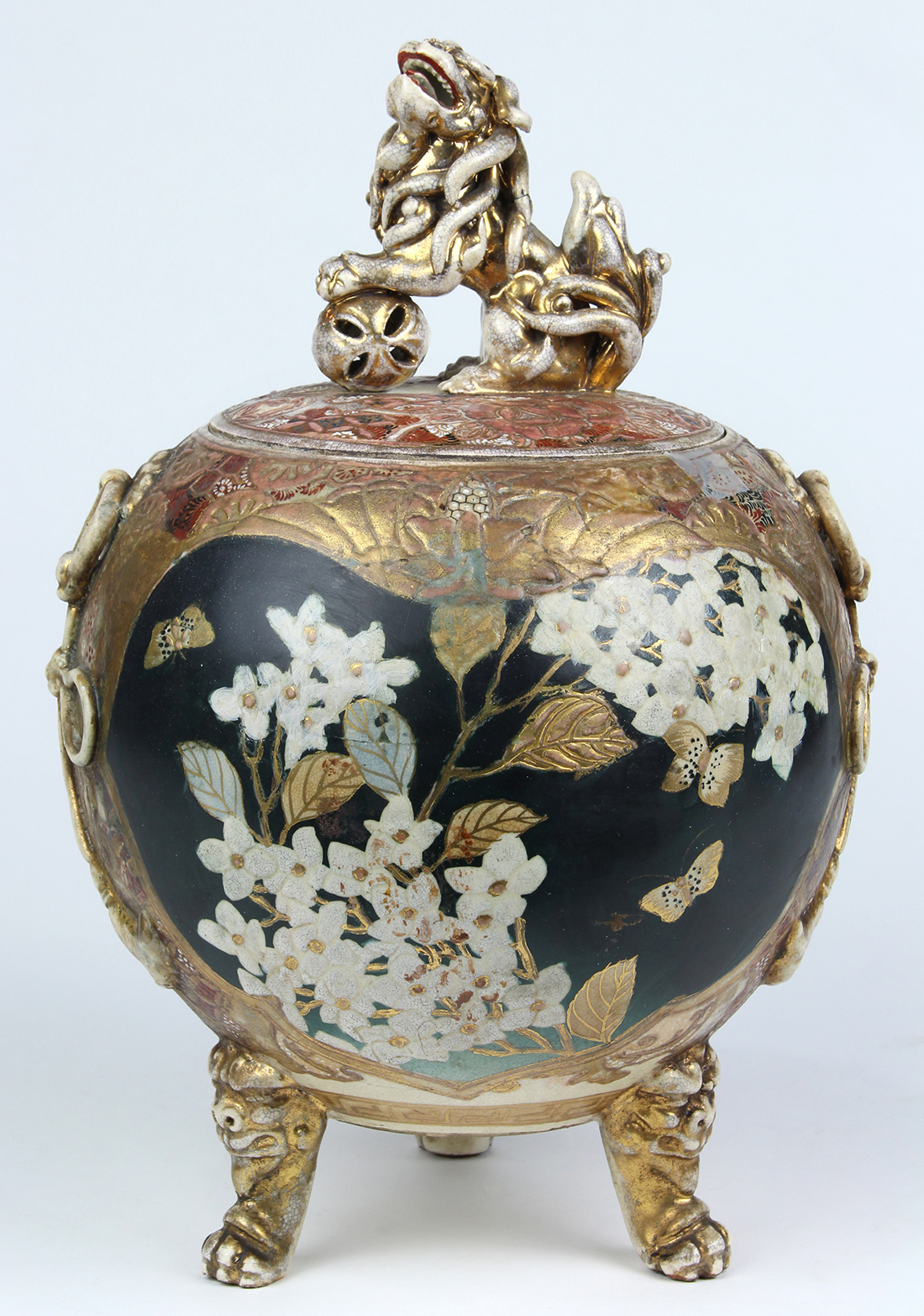 Japanese Satsuma ceramic jar, the lid with a lion form finial, above a globular body having floral