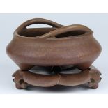 Chinese bronze censer and stand, with curved handles on the rim above the low slung body, raised