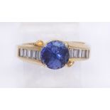 Tanzanite, diamond and 14k yellow gold ring featuring (1) round-cut tanzanite, weighing