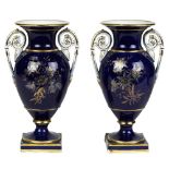 (lot of 2) Meissen porcelain urns, each having a gilt rim, above a cobalt body having a Classical