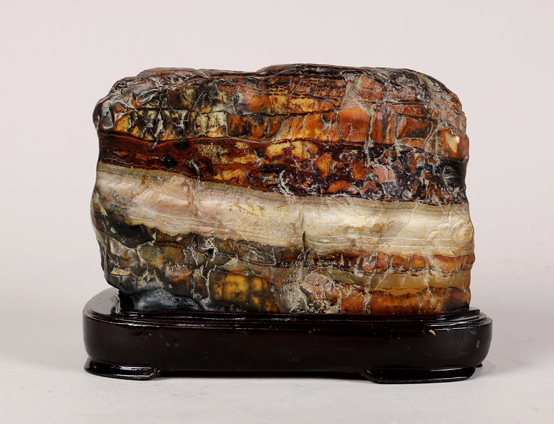 Chinese scholar's rock, reminiscent of a cooked pork belly, with layers of mottled brown and tan