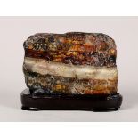Chinese scholar's rock, reminiscent of a cooked pork belly, with layers of mottled brown and tan