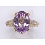 Kunzite, diamond and 14k yellow gold ring Featuring (1) oval-cut kunzite, weighing approximately 7.