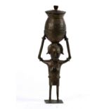 West African bronze currency figure, depicting a stylized figure carrying a hinged lid basket