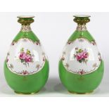 Pair of Royal Crown Derby porcelain vases, each having a bulbous form with floral reserves on a