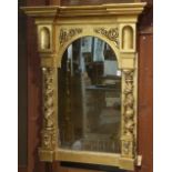 Renaissance style gilt looking glass, having an architectural crest surmounting the shaped looking