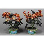 Pair of Chinese stone plants, each with carnelian flower petals with dark hardstone leaves,