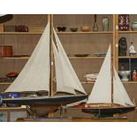 (lot of 2) Model ship group, each executed in wood, depicted full sail, and rising on a conforming