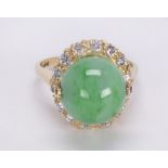 Jadeite, diamond and 14k yellow gold ring Featuring (1) jadeite bead, measuring 12.0 mm,