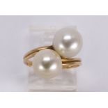 Cultured pearl and 18k yellow gold ring Featuring (2) cultured pearls, measuring approximately 10