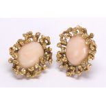 Pair of coral and 14k yellow gold earrings Featuring (2) oval coral cabochons, measuring