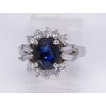 Sapphire, diamond and 10k white gold ring Centering (1) oval-cut sapphire, weighing approximately