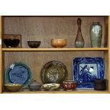 (lot of 13) Two shelves of mostly Japanese ceramics: consisting of bowls, vases and plates;