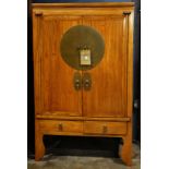 Chinese wooden clothing cabinet, fronted by a pair of hinged double doors concealing shelf and