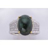 Tourmaline, diamond and 14k white gold ring Centering (1) oval green tourmaline cabochon,