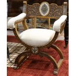 Continental savonarola style armchair, having a carved back and rising on shaped legs terminating on