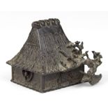 Japanese bronze water dropper, of a thatched roof house fronted by a flowering cherry tree, base