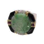 Jadeite, ruby, diamond, black onyx and 14k yellow gold ring Centering (1) round jadeite plaque,