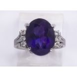 Amethyst, diamond and platinum ring Featuring (1) oval-cut amethyst, weighing approximately 5.20