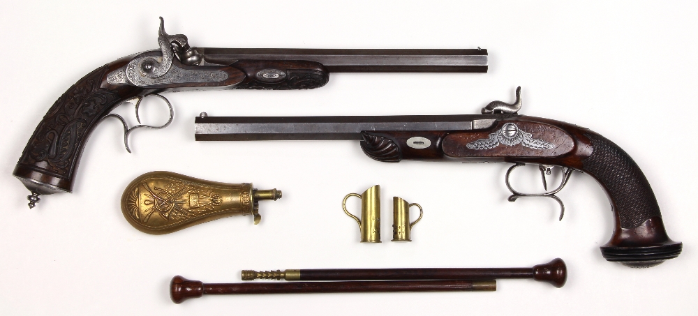 Cased set of French target pistols, mid-19th century, one dueling pistol with ornate foliate