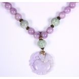 Jadeite, amethyst, 14k yellow gold and silver bead necklace Featuring (1) carved and pierced jadeite
