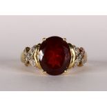 Garnet, diamond and 14k yellow gold ring Featuring (1) oval-cut garnet, weighing approximately 5.