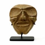 Taíno society vertigated serpentine mask, the expressive face with graphic symbolism and residual