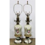 Pair of Continental porcelain table lamps, each having partial gilt decoration with floral reserves,