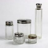 (lot of 5) Silvered and cut glass vanity articles, each having a chased and threaded lid, rising
