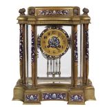 French champleve decorated mantle clock, having a floral decorated case with bevelled glass