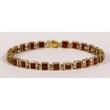Garnet and 14k yellow gold bracelet Featuring (25) square-cut garnets, weighing a total of