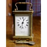 French carriage clock, retailed by Hamilton and Co., having a brass case, with beveled glass, 4.5"h