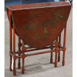 Continental Chinoiserie decorated gate leg table, the laquered oval top with scenic depictions of