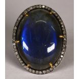 Labradorite, diamond and silver gilt ring Centering (1) oval labradorite cabochon, measuring