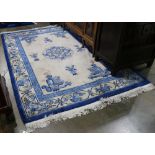 Chinese blue rug with central medallion and auspicious symbols, 9' 3" x 6'.
