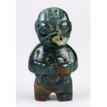 Pre-Columbian Olmec style miniature jade figurine, standing in a characteristically stiff pose,