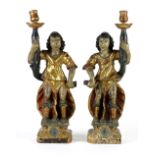 Pair of Italian figural candle holders circa 1690, each having polychrome decoration on lime wood,