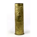 Trench art style artillery shell vase, having a cylindrical form, the smooth rim over a foliate